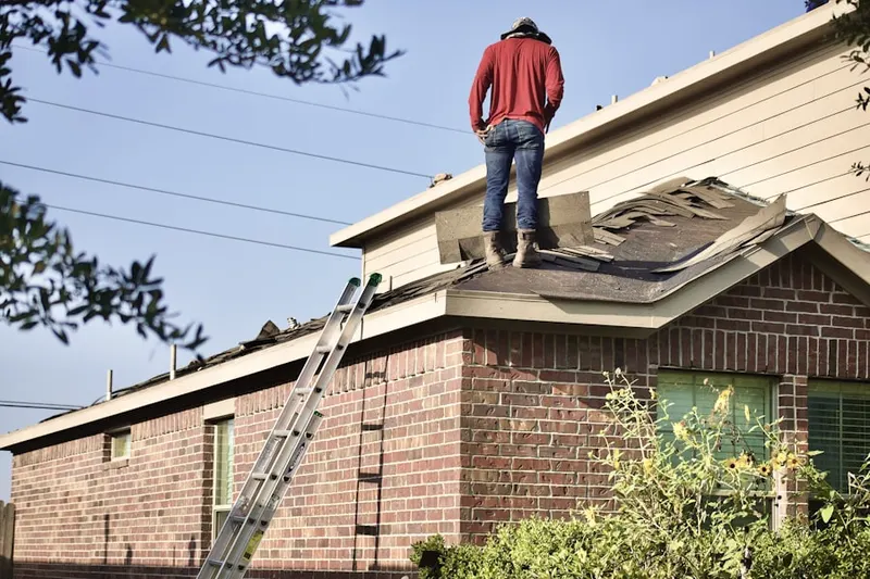 Professional roofer working on a residential roof in Downtown Haverhill